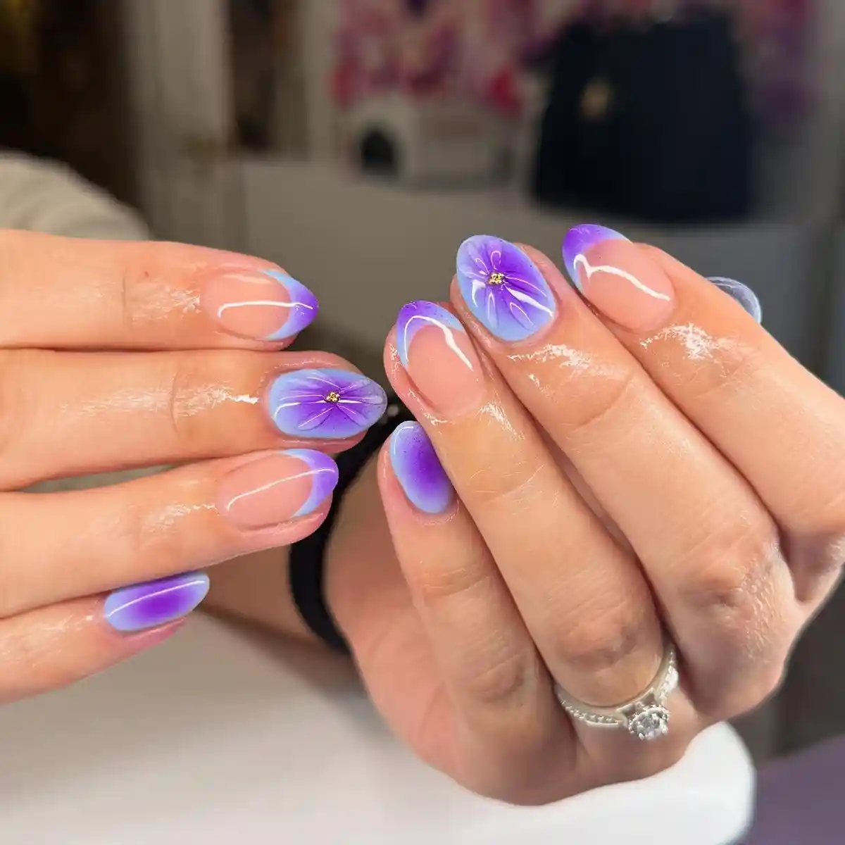 Soft purple gradient tips with delicate flower accents