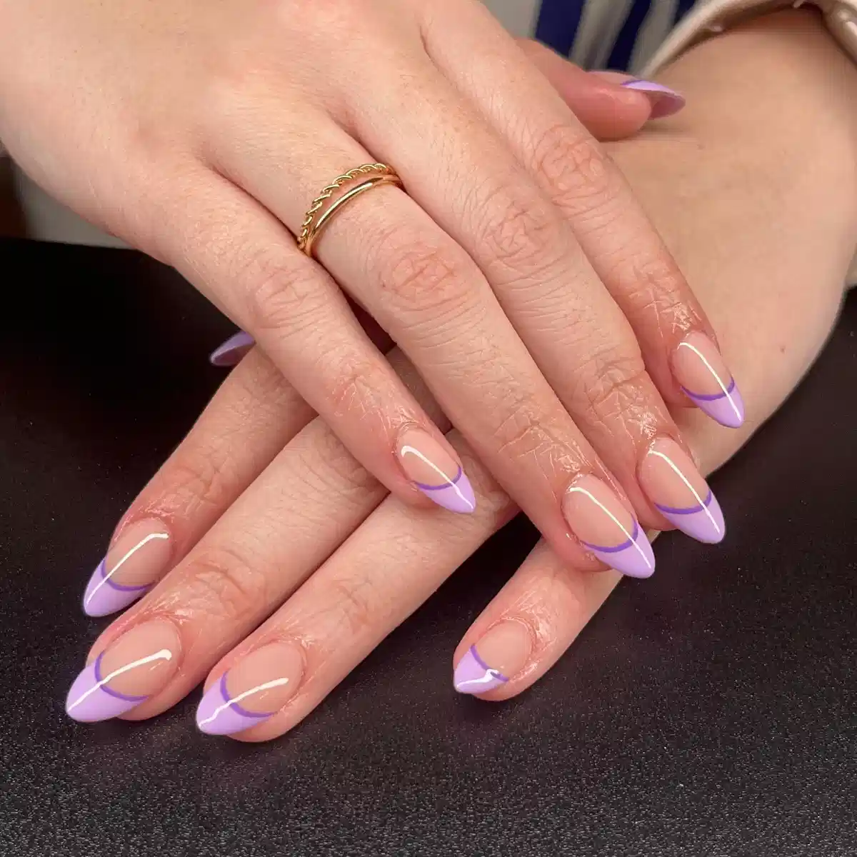 Thin curved lavender French lines on almond nails