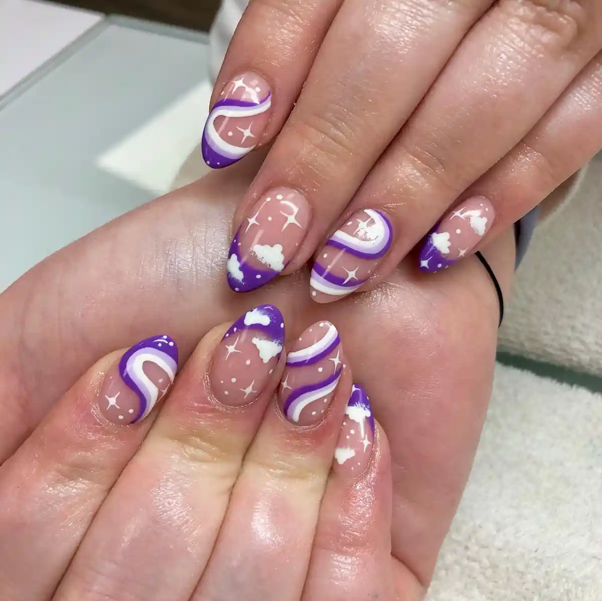 Purple French tips with clouds, stars, and wavy white stripes