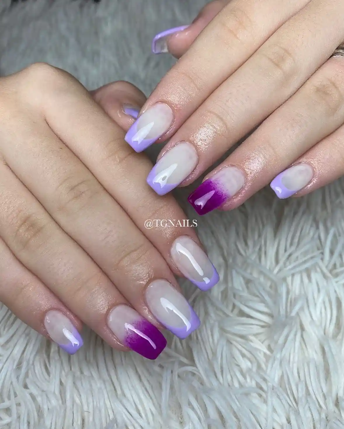 Milky nude base with lavender French tips and purple gradient accents