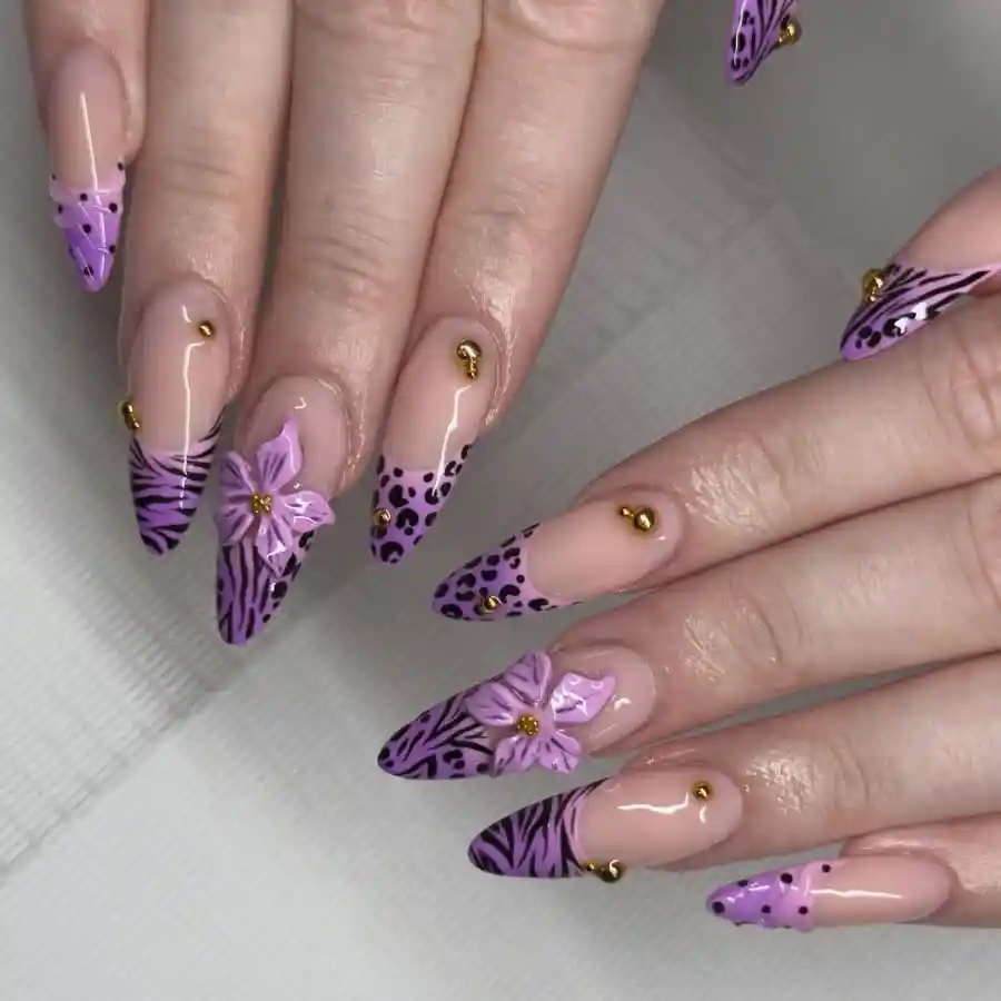 Stiletto nude base with purple patterned tips and 3D flowers