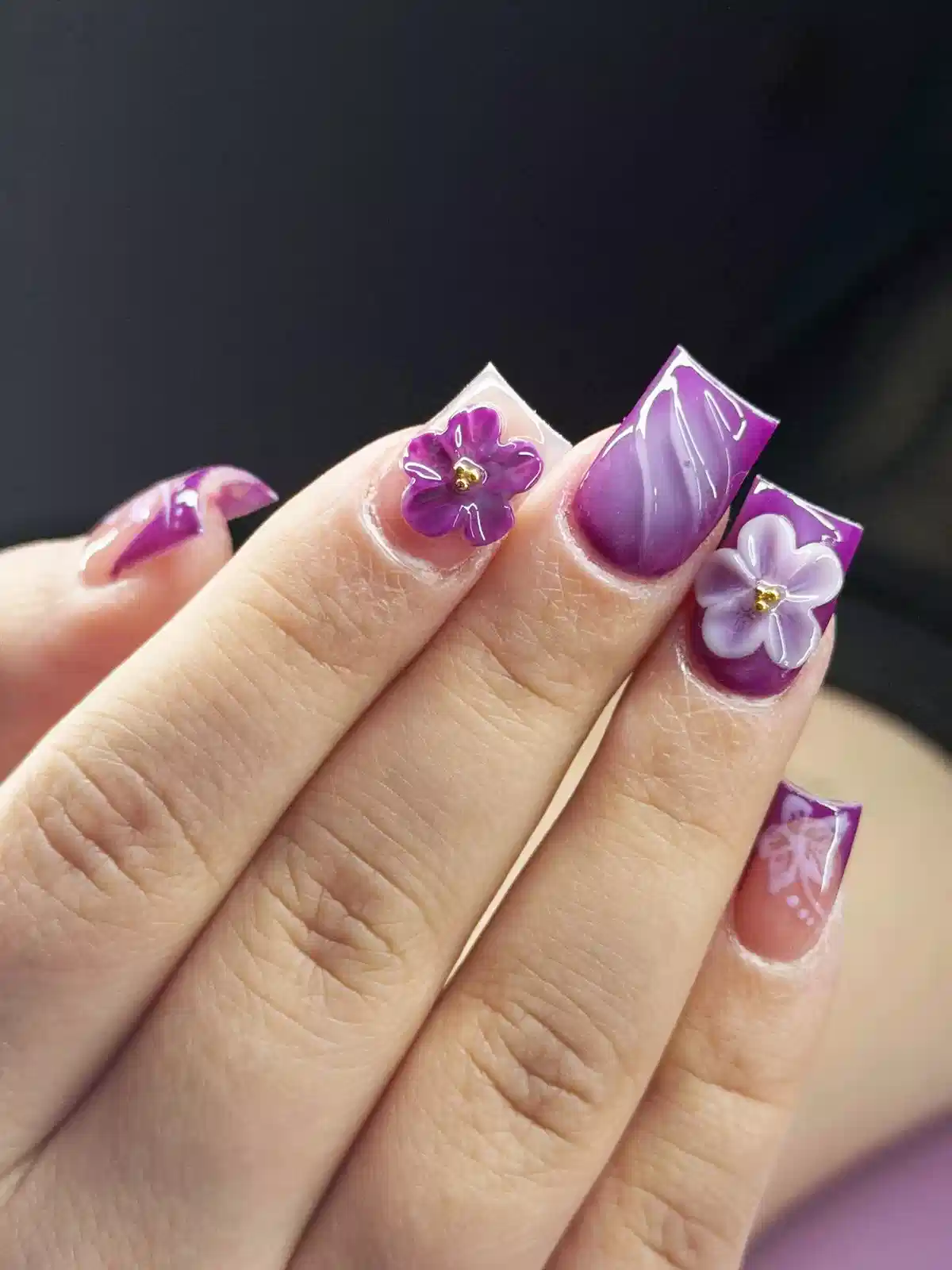 Short square purple French tips with 3D flower accents