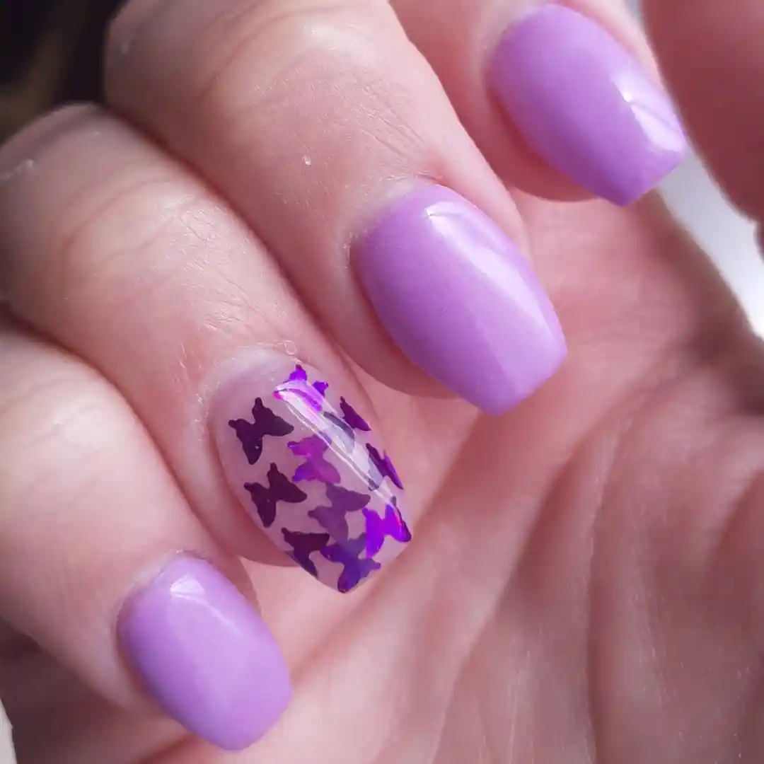 Lavender short nails with purple butterfly accent