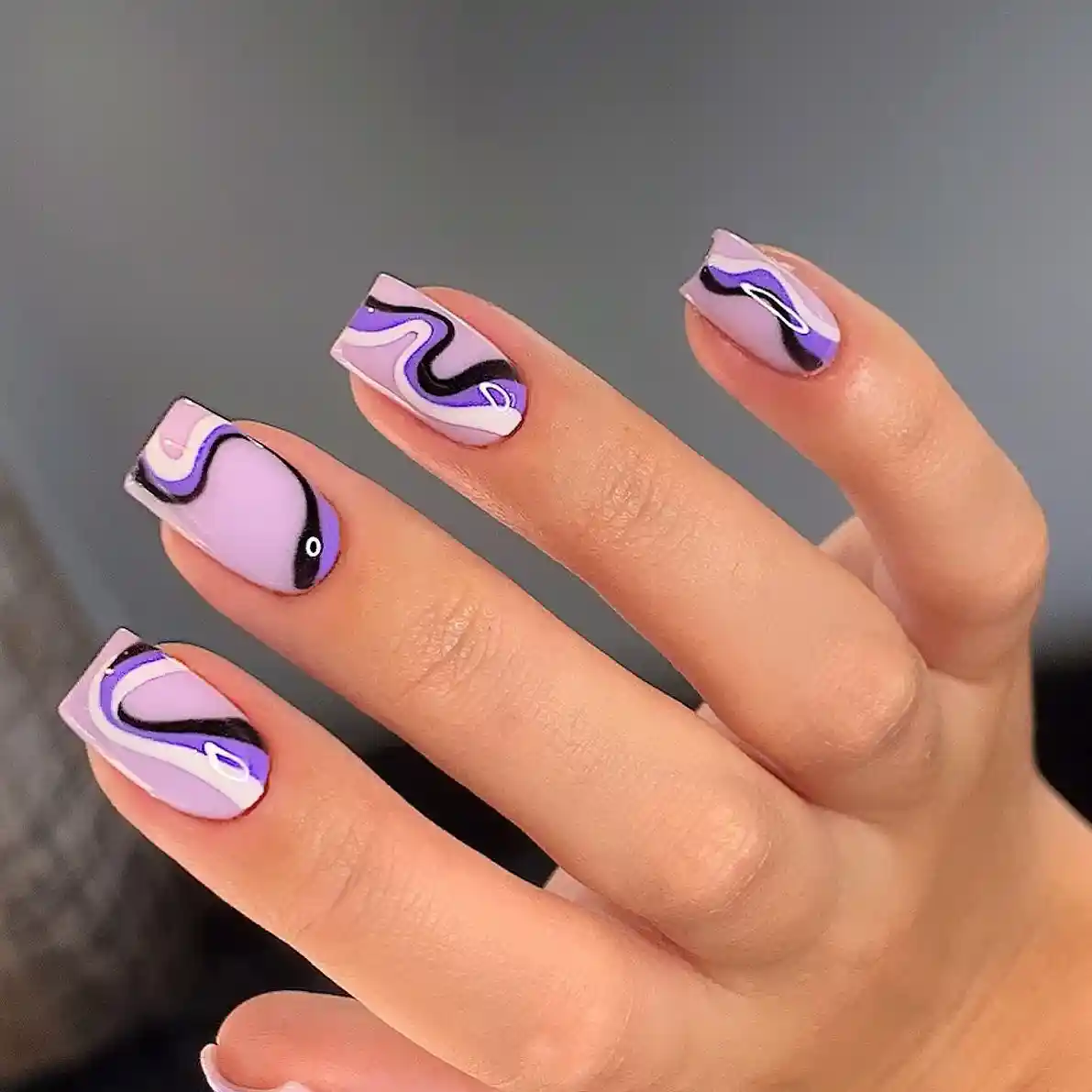 Lavender swirl nails with black and purple curves