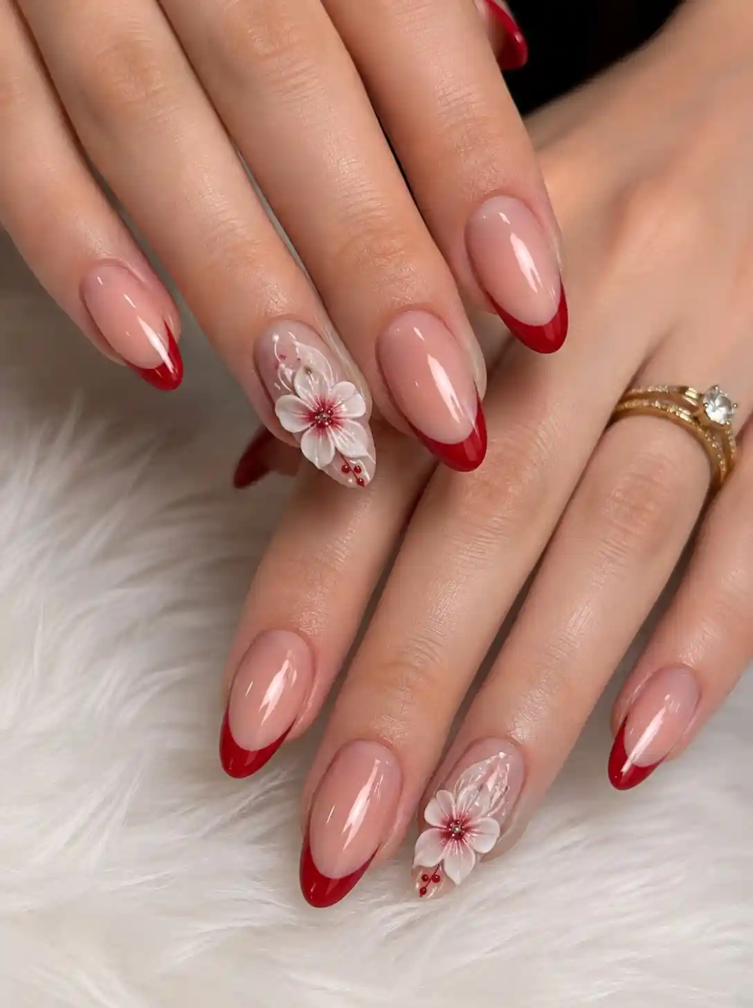 Classic red French tips with raised white floral accents