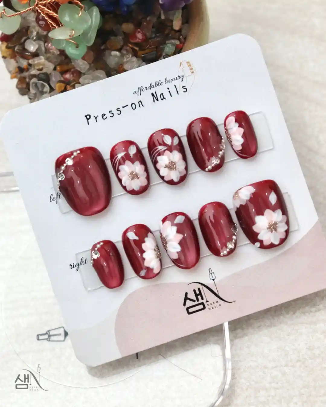 Deep red floral press-on set on display card