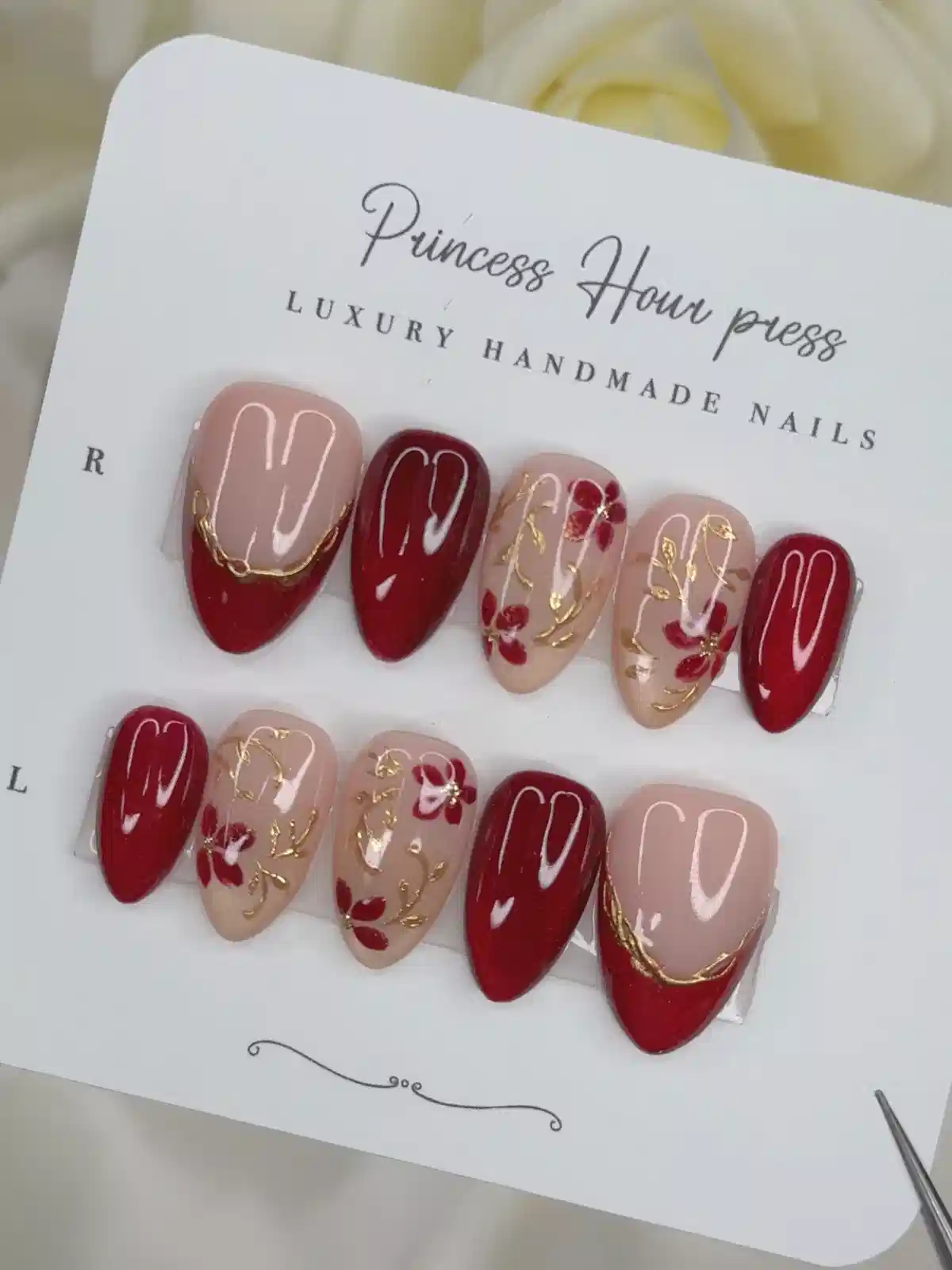Red and nude floral press-ons with gold vine detailing