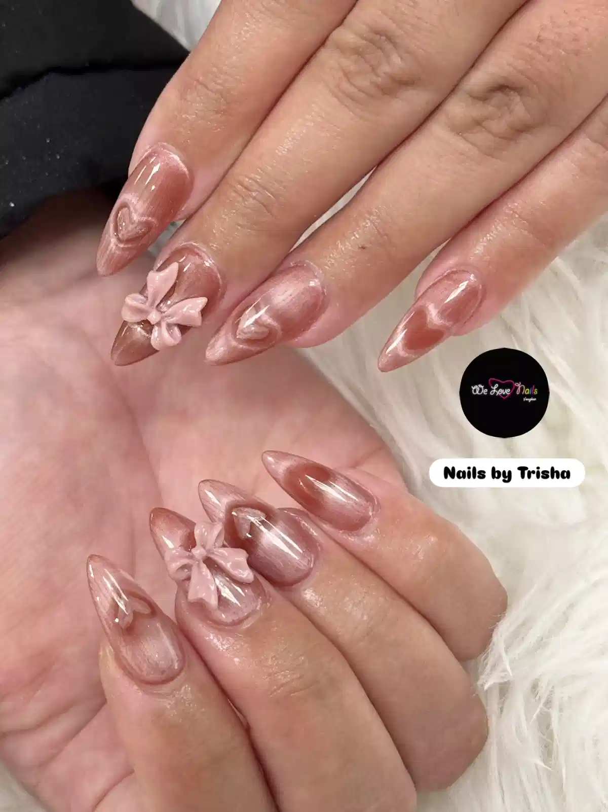 Glossy rose-toned stiletto nails with 3D bows
