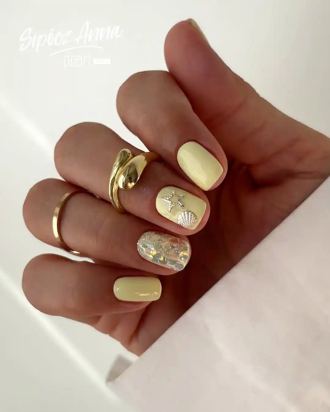 Pale Yellow Nails with Star, Shell, and Iridescent Accent