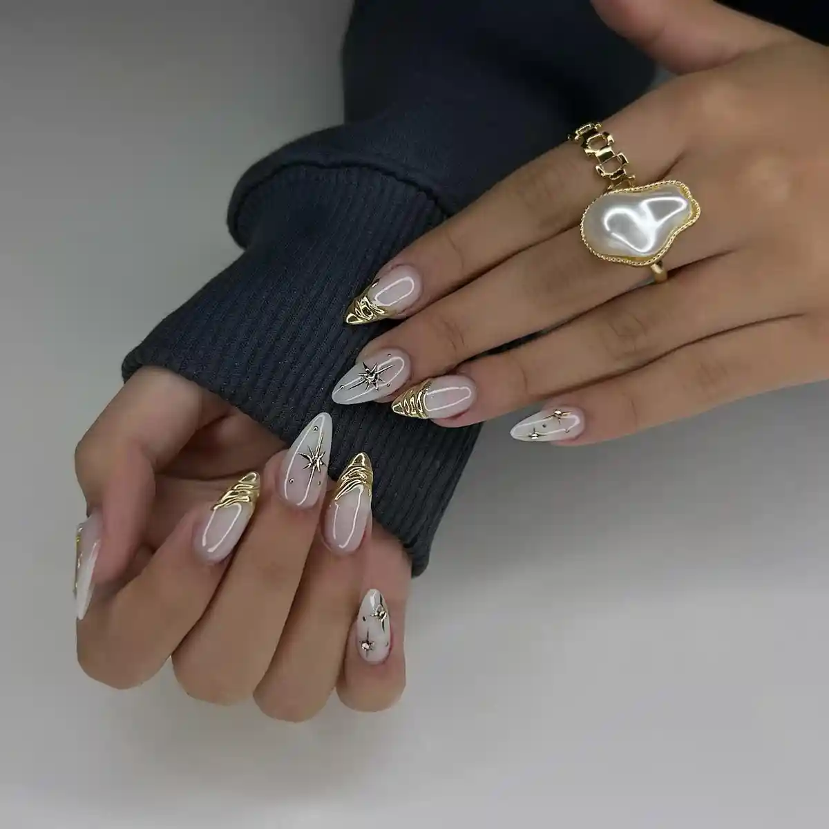 Nude nails with gold metallic tips and star accents
